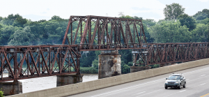 Derided by some as a blight, but also eligible for listing on the National Register of Historic Places, a trackless former railroad bridge next to the Ohio Turnpike’s Maumee River bridge is to be torn down next year.